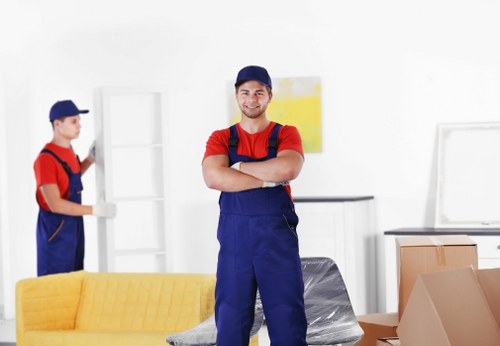 Removal van and moving team working on a residential street in Highbury