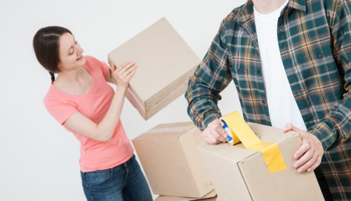 Professional movers handling boxes and furniture during a Highbury home relocation