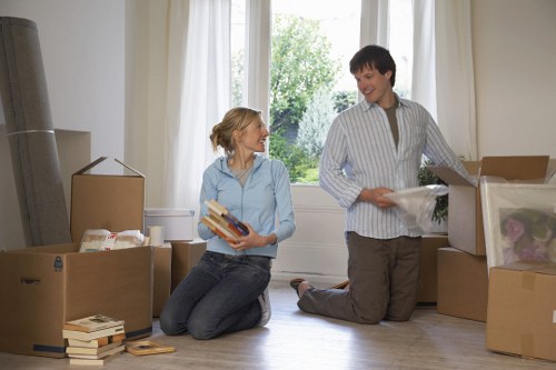 Movers carrying household items through a Highbury property