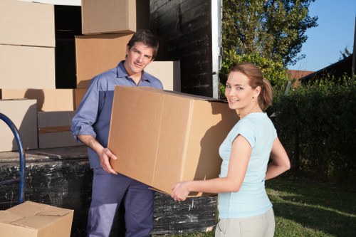 Specialist movers transporting an upright piano in Highbury